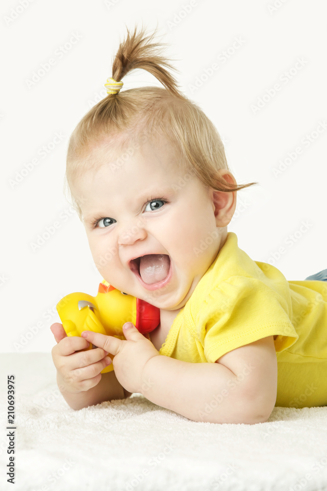Studio portrait of adorable baby girl playing with yellow rubber duck Studio portrait of adorable baby girl playing with yellow rubber duck