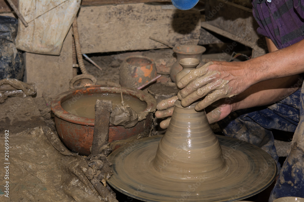 Hands of Professional Thai man using mechanic pottery made earthenware at Hands of Professional Thai man using mechanic pottery made earthenware at