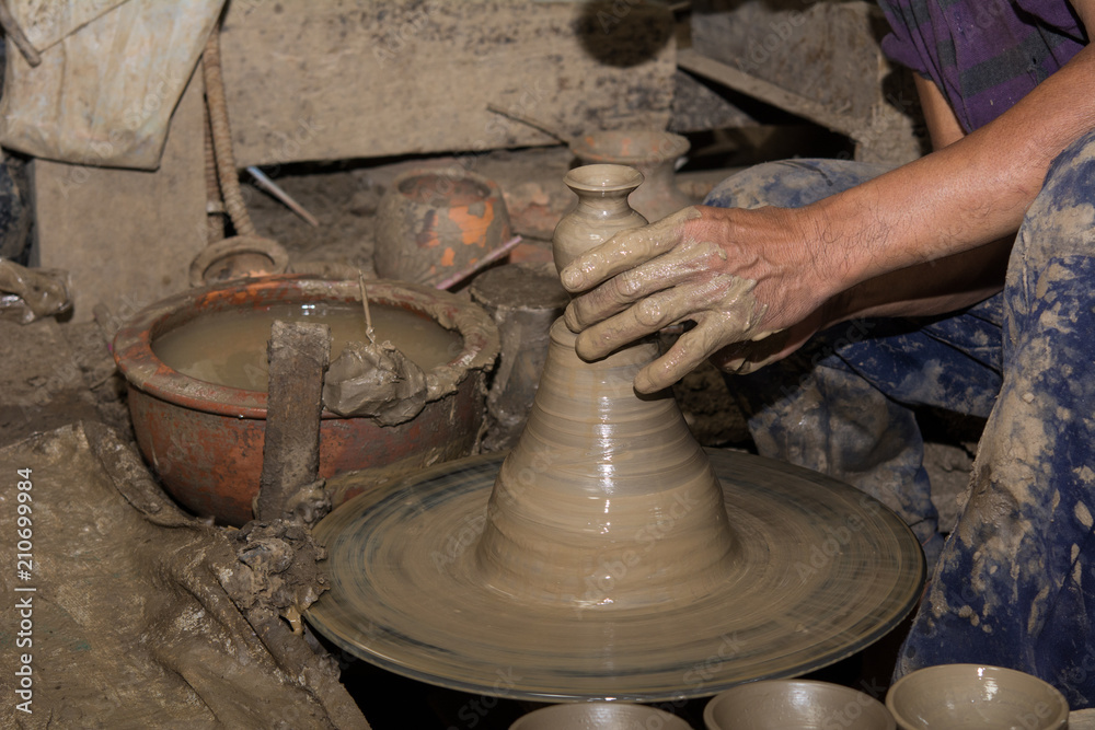 Hands of Professional Thai man using mechanic pottery made earthenware at Hands of Professional Thai man using mechanic pottery made earthenware at