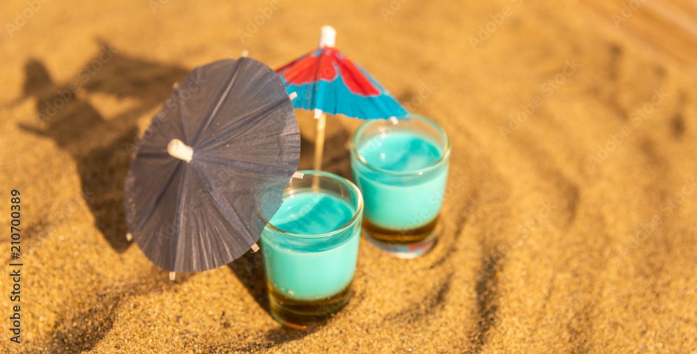 colorful shots drinks on a sandy beach with umbrellas for drinks colorful shots drinks on a sandy beach with umbrellas for drinks