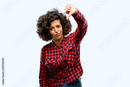 Photos Beautiful arab woman showing thumbs down unhappy sign of dislike, negative expre