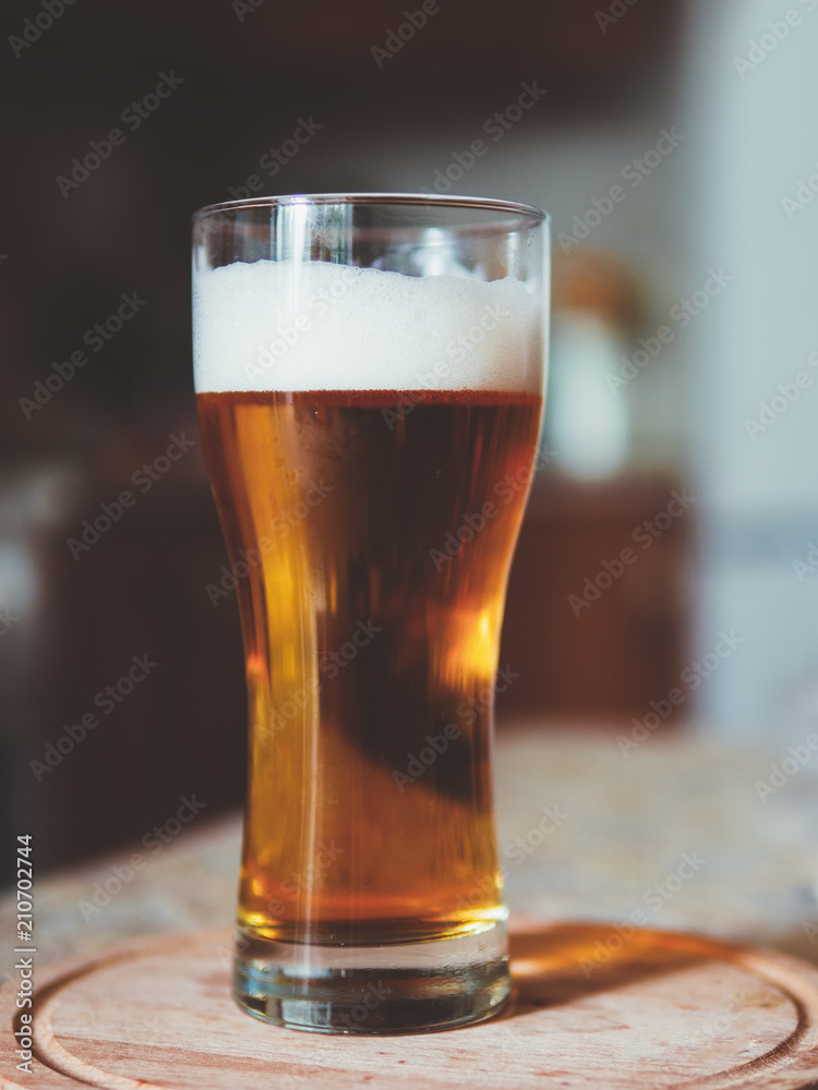 Glass of cold light beer on the kitchen table Glass of cold light beer on the kitchen table