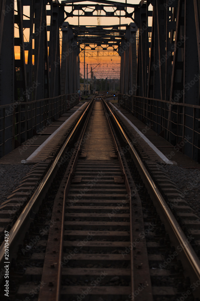 steel railway bridge on sunset