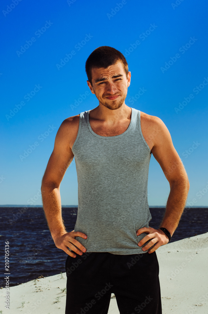 Fototapeta premium the guy with dark hair. bright sun light is blinding