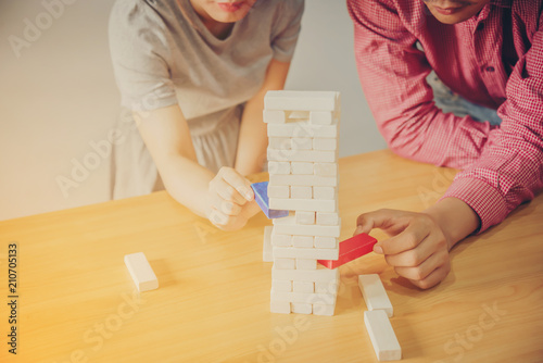 business people playing wooden tower game, Planning concept, risk concept, strategy concept, soft focus photo