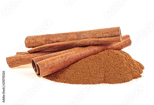 Cinnamon sticks and ground cinnamon on white background