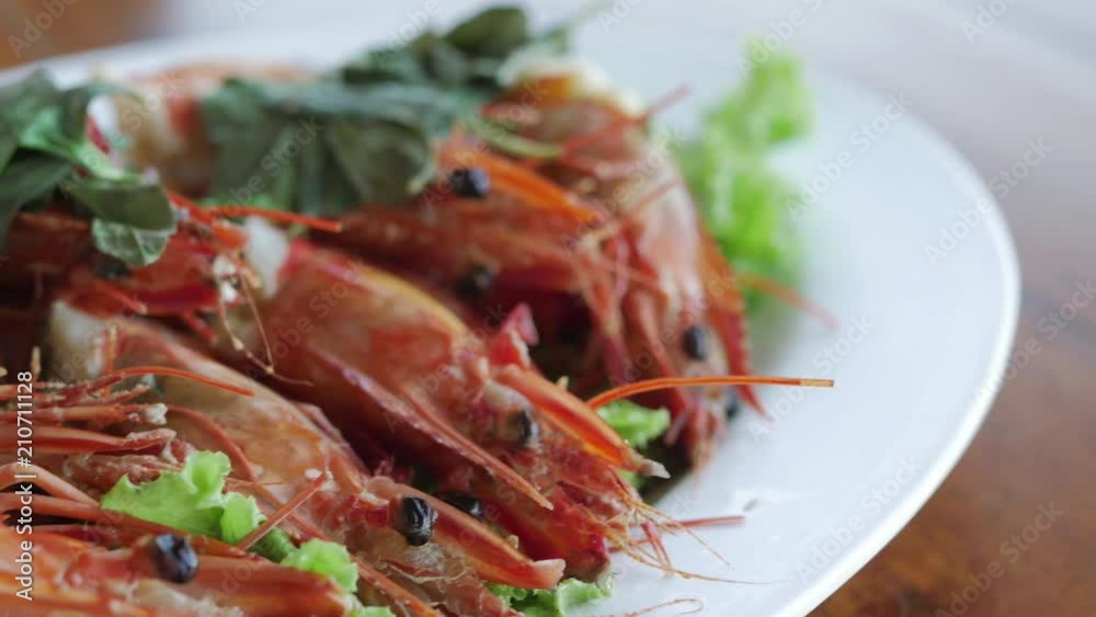 Barbecued grilled prawns with basil leaves. Restaurant Seafood dish. Barbecued grilled prawns with basil leaves. Restaurant Seafood dish.