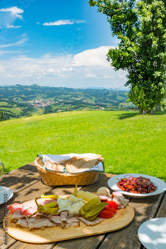 Brettljause with view over meadow to south styrian wine route