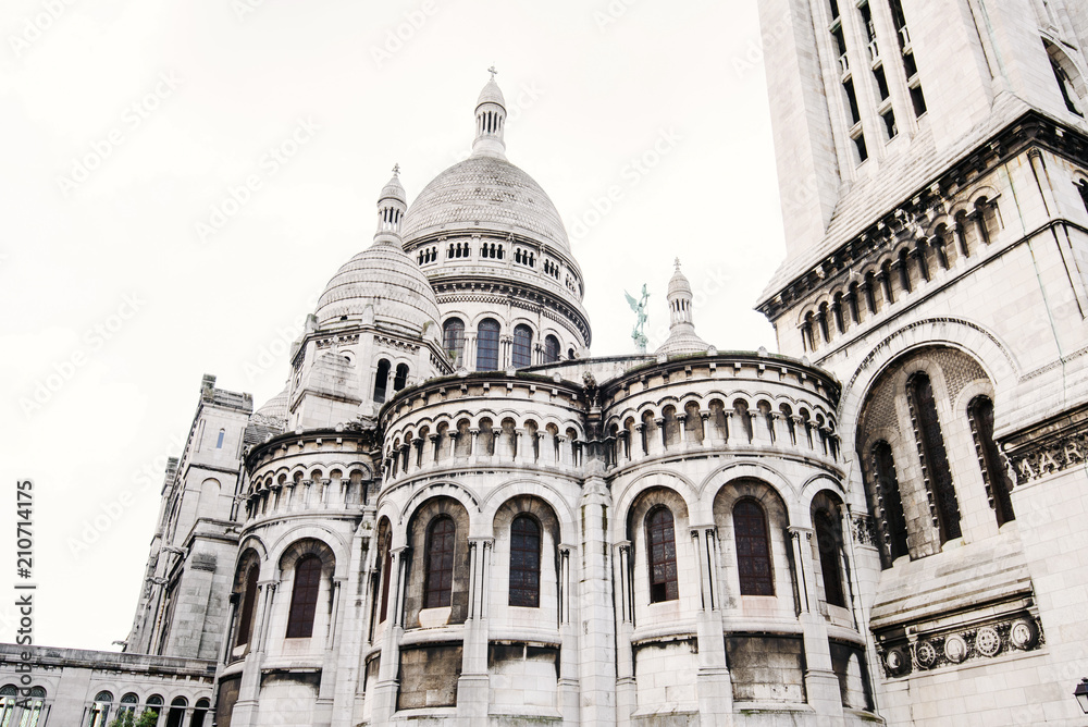 Paris, France - August 10, 2017. Domes of Sacre Coeur basilica or Basilica of the Sacred Heart of Paris on the top of Montmartre hill. Old Roman Catholic church, popular touristic landmark. Paris, France - August 10, 2017. Domes of Sacre Coeur basilica or Basilica of the Sacred Heart of Paris on the top of Montmartre hill. Old Roman Catholic church, popular touristic landmark.