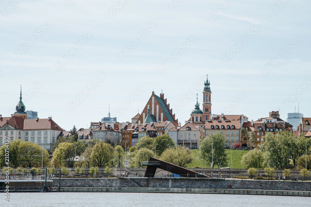 Naklejka premium City over the river. Warsaw over the Vistula. The old town is the Polish and Viennese Boulevards. Old and owen parts of the city. Architecture. Temples and churches. High-rise buildings and historic