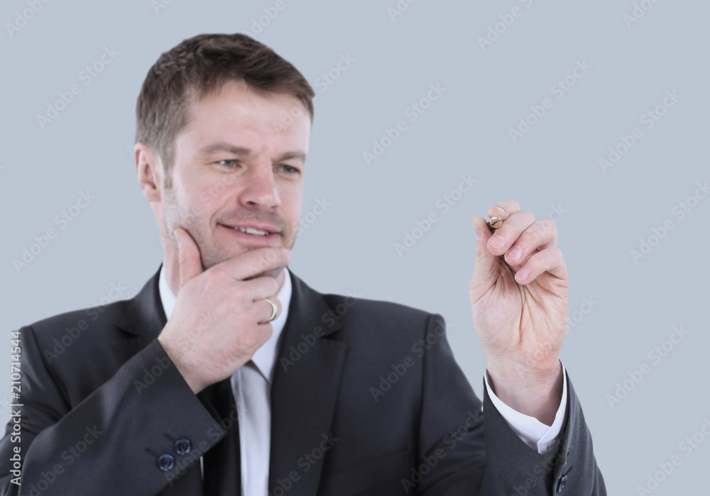 Business man writing on an imaginary board. Isolated on gray. Business man writing on an imaginary board. Isolated on gray.