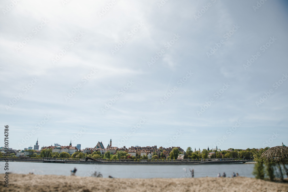 Fototapeta premium City over the river. Warsaw over the Vistula. The old town is the Polish and Viennese Boulevards. Old and owen parts of the city. Architecture. Temples and churches. High-rise buildings and historic
