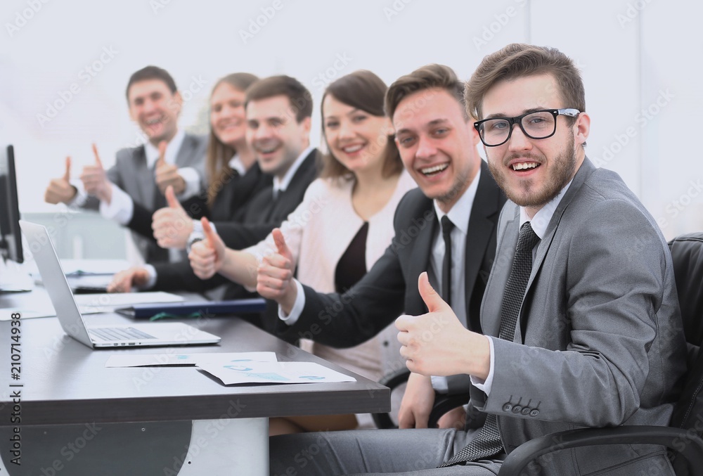 business team with thumbs up while sitting at his Desk business team with thumbs up while sitting at his Desk