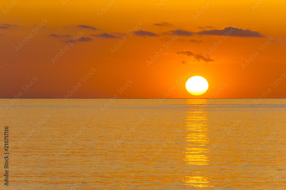 Mallorca, Orange sunrise reflecting on ocean water