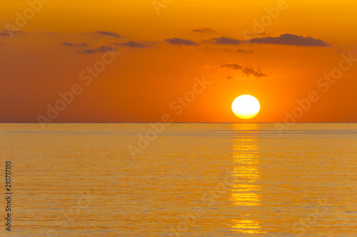 Mallorca, Orange sunrise reflecting on ocean water © Simon