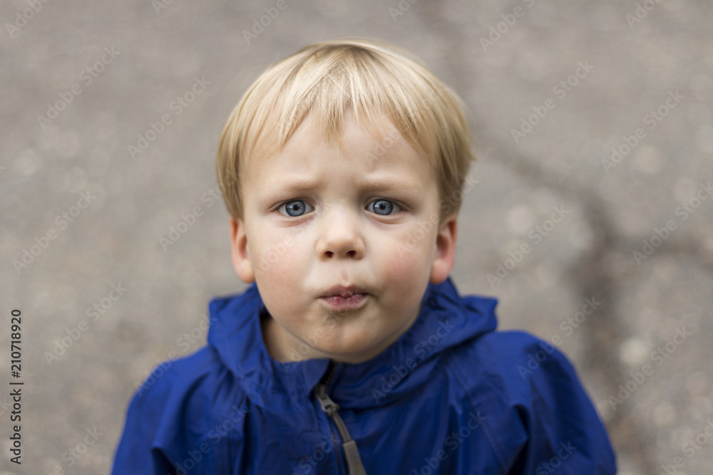 Outdoor portrait of beautiful toddler boy looking at camera Outdoor portrait of beautiful toddler boy looking at camera