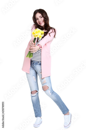 Young woman with narcissus flowers on white background