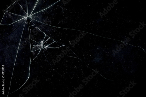 A broken glass on a black background, shattered pieces not too far away from each other. Useful texture for overlay.
