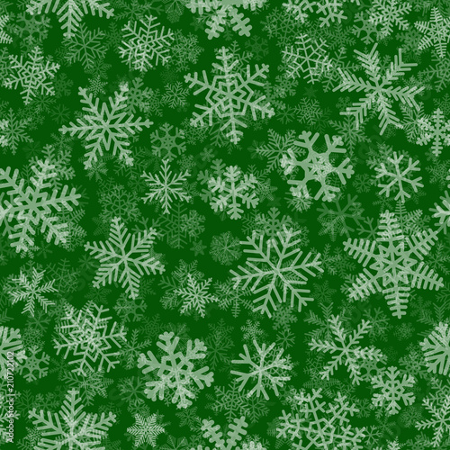 Christmas seamless pattern of many layers of snowflakes of different shapes, sizes and transparency. White on green background