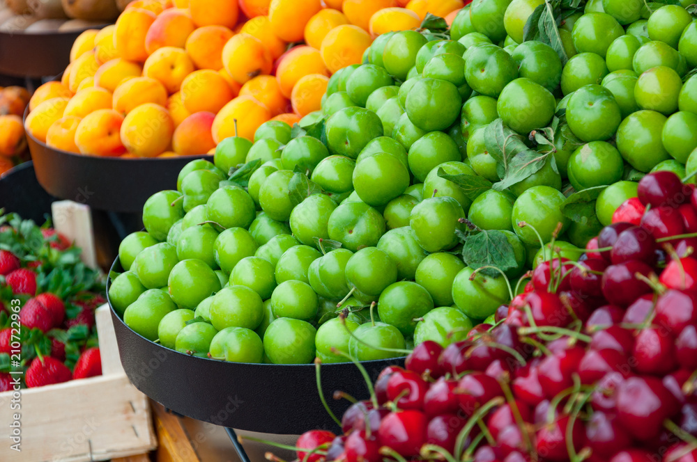 Various fruits and berries on a marketplace, close-up