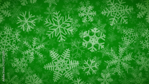 Christmas background of many layers of snowflakes of different shapes, sizes and transparency. White on green.