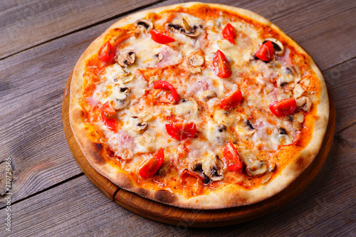 Pizza with cherry tomatoes, ham and mushrooms, traditional Italian recipe, delicious mediterranean meals. Food delivery, restaurant, pizzeria menu concept
