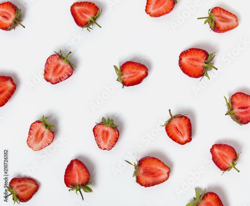 Halves of strawberries on the white background.