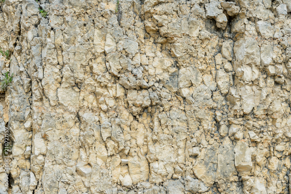 Textured stone background Rubble ballast in natural form in the rock wall Textured stone background Rubble ballast in natural form in the rock wall
