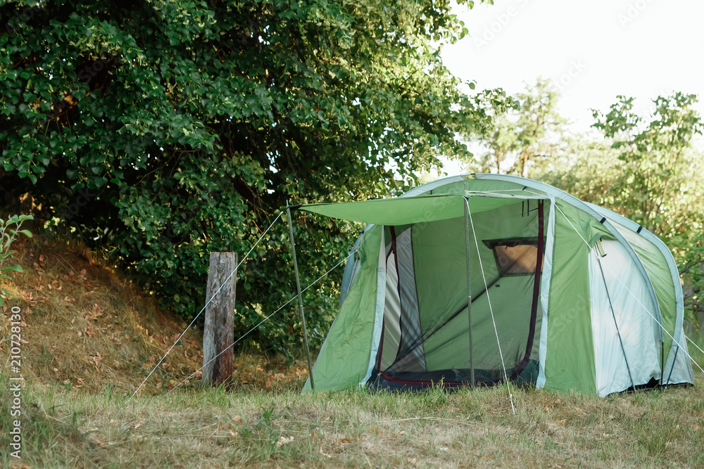 tent in the autumn forest, home for adventure and travel