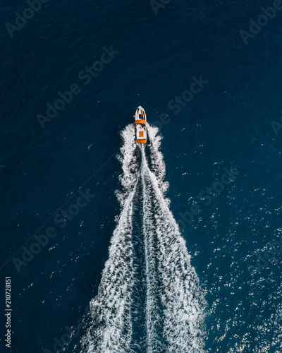 Motor boat cruising along the Atlantic ocean coast during a sunny day