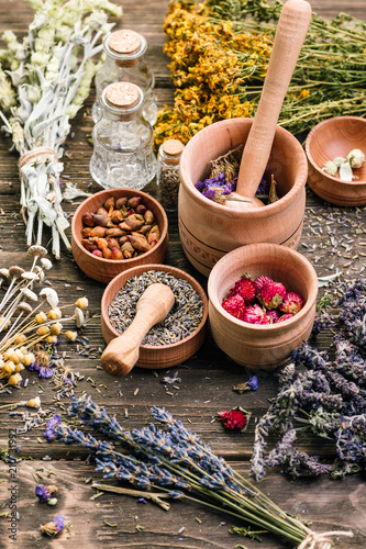 Bild auf Leinwand Wild Herbs Different Gathering of Medicinal Alternative Treatment Wooden Backgro
