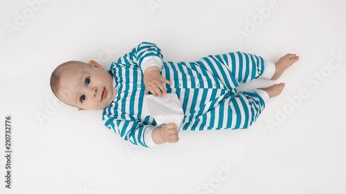 Baby playing with paper boat photo