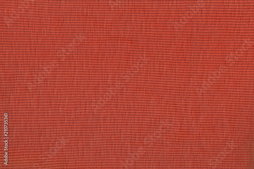 Red fabric texture background. Empty abstract cloth backdrop