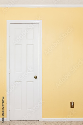 Clean white door, white trim, yellow wall
