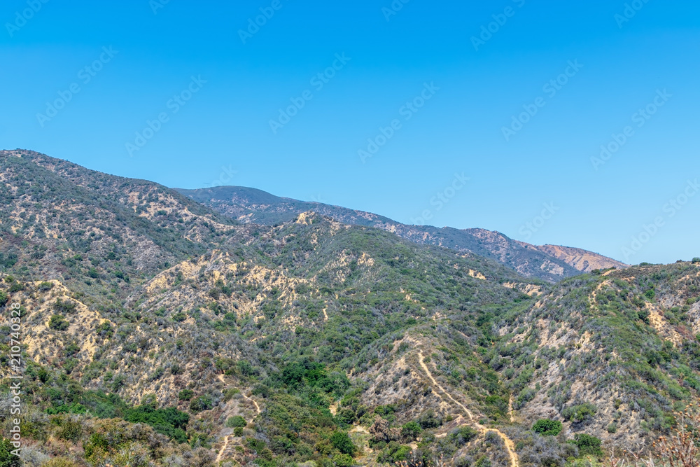 Hiking and biking trails cover California mountains on clear summer morning