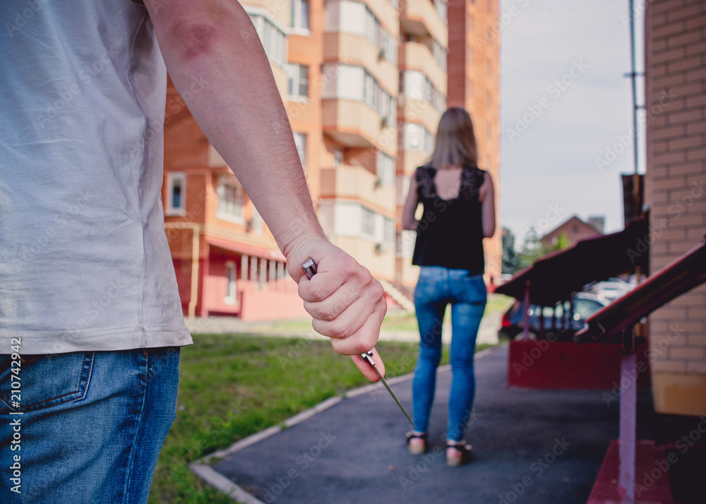 Dangerous man with knife behind the woman Dangerous man with knife behind the woman