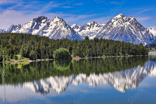 The Grand Tetons of Wyoming are reflected perfectly in the still waters of Jackson Lake © aceshot