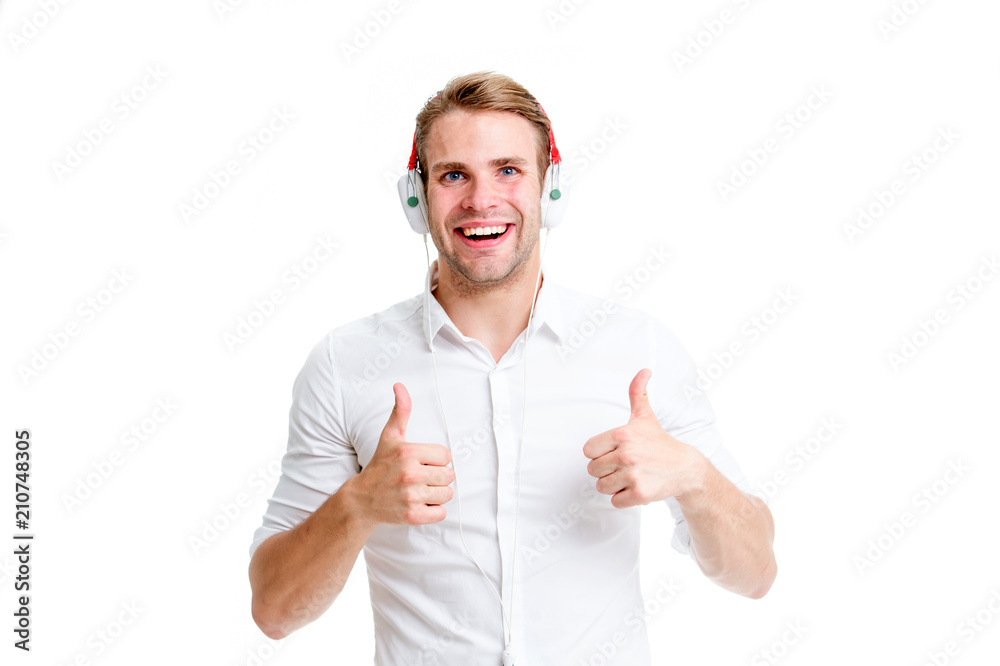 Best song ever. Man listening favourite song in headphones shows thumbs up.  Man happy face enjoy listening music radio isolated white background. Guy  with earphones listening best songs radio chart Stock Photo