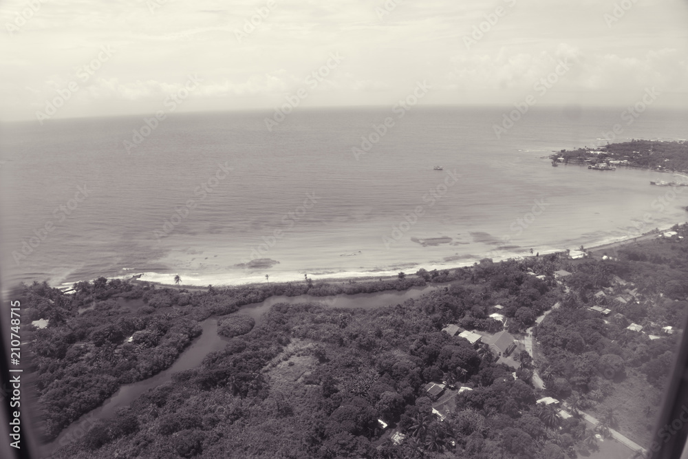 black and white view of the beach edge from the sky