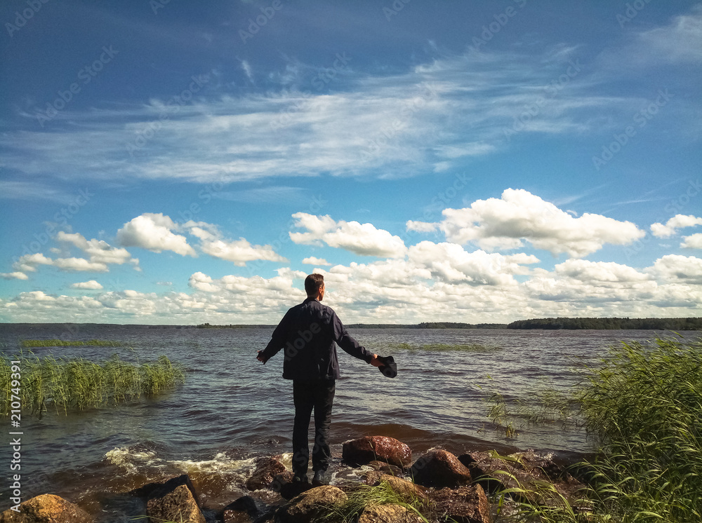 Man back on the beach enjoys nature.