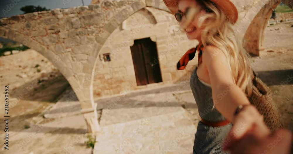 Woman holding hands with boyfriend on summer holidays in Europe