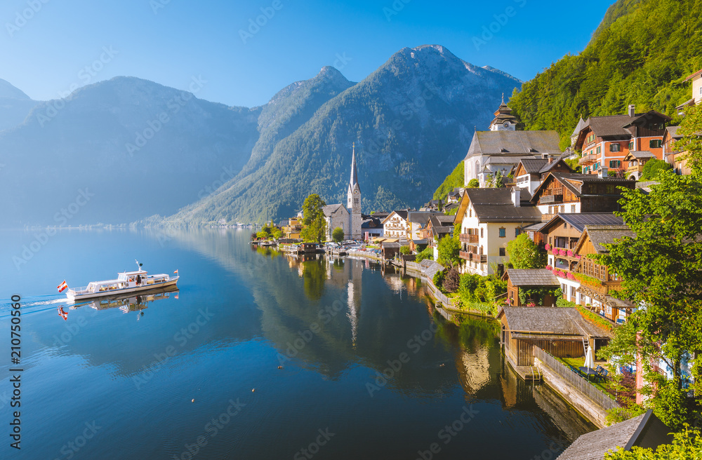 Classic view of Hallstatt with ship at sunrise in summer, Austria