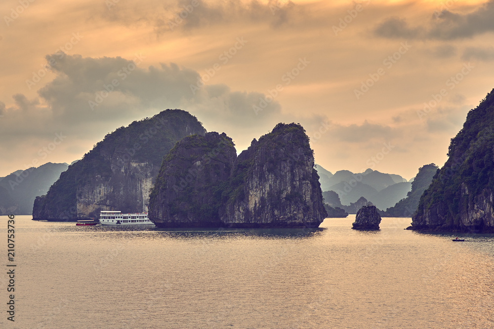 Halong bay boats, Vietnam Panoramic view of sunset in Halong Bay, Vietnam, Southeast Asia,UNESCO World Heritage Site, Poor lighting conditions