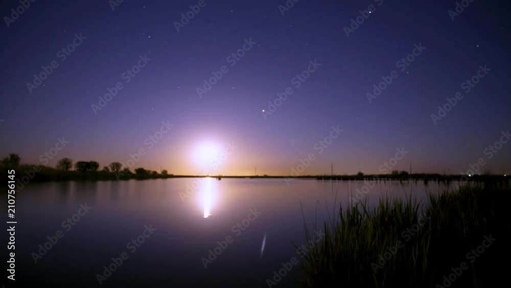 Full Moon Over Lake Time Interval. A starry night sky. Full Moon Over Lake Time Interval. A starry night sky.