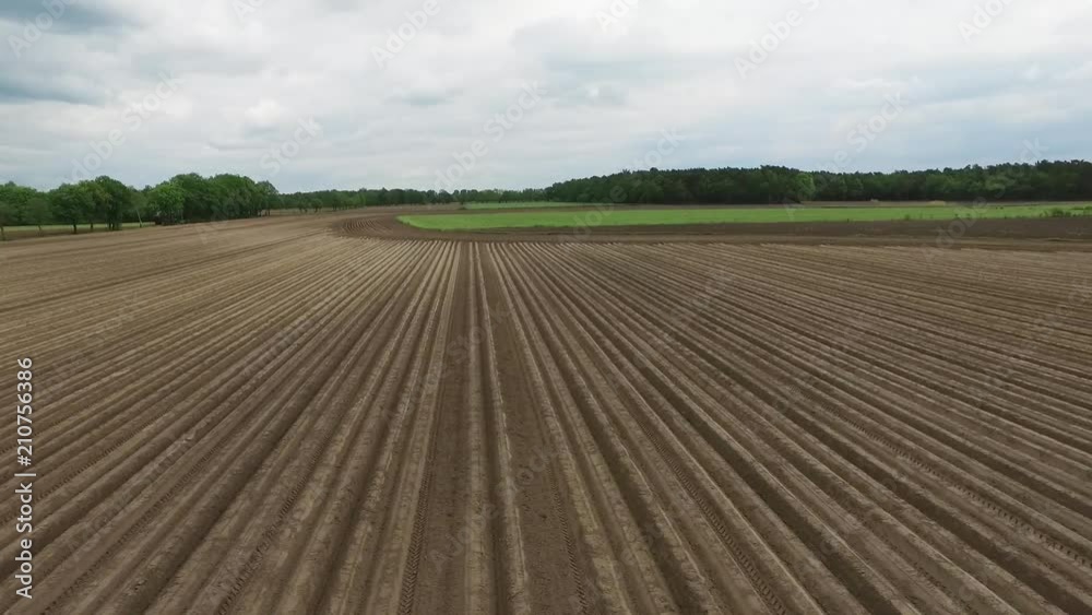 Wide aerial, scenic farmland field