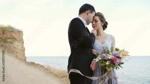 the bride and groom on the beach photo