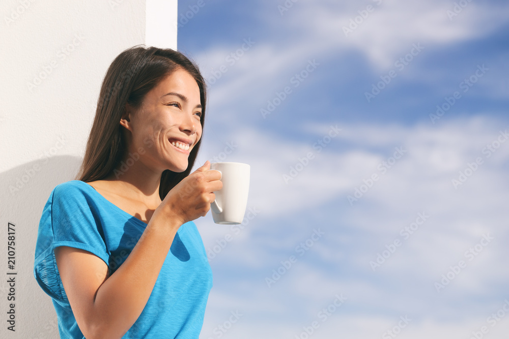Woman drinking coffee during morning breakfast at home enjoying fresh cafe outdoor balcony view. Asian girl smiling on summer lifestyle healthy eating. Woman drinking coffee during morning breakfast at home enjoying fresh cafe outdoor balcony view. Asian girl smiling on summer lifestyle healthy eating.