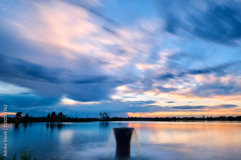The oil pumping units and cloudscape sunset. The oil pumping units and cloudscape sunset.
