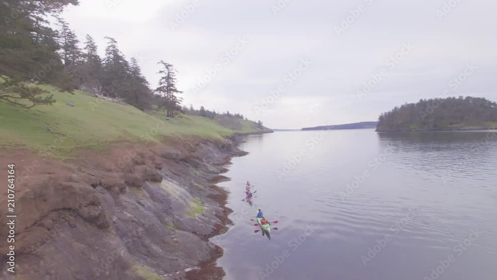 Aerial, people kayak off shore of San Juan Islands Aerial, people kayak off shore of San Juan Islands