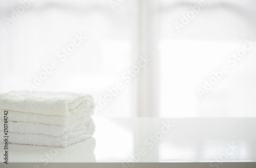 Towels on white table with copy space.